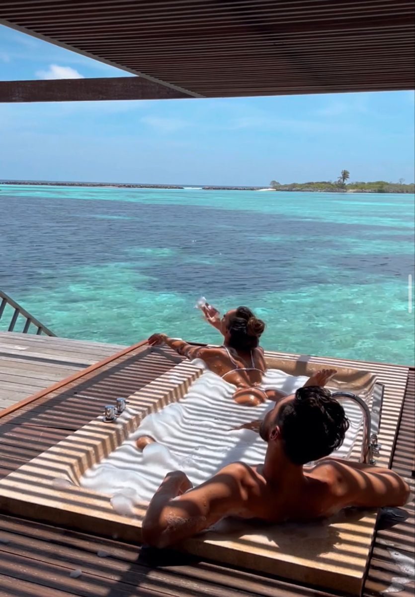 Creators filming from a sun deck above turquoise water